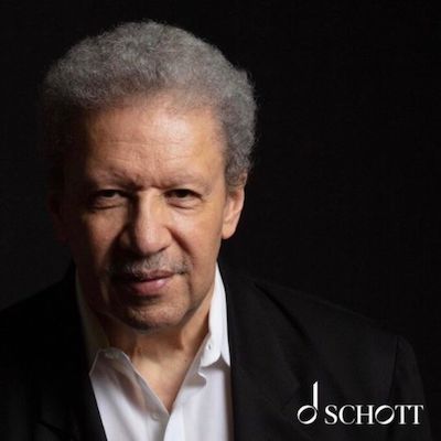 A black background with professor Anthony Davis in the foreground. On the bottom right is a music note with the word SCHOTT.